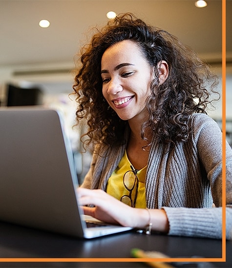 woman smiling working at laptop