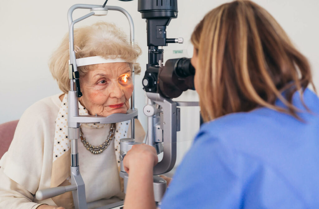 A senior woman undergoing a slit lamp examination to see signs of macular degeneration.
